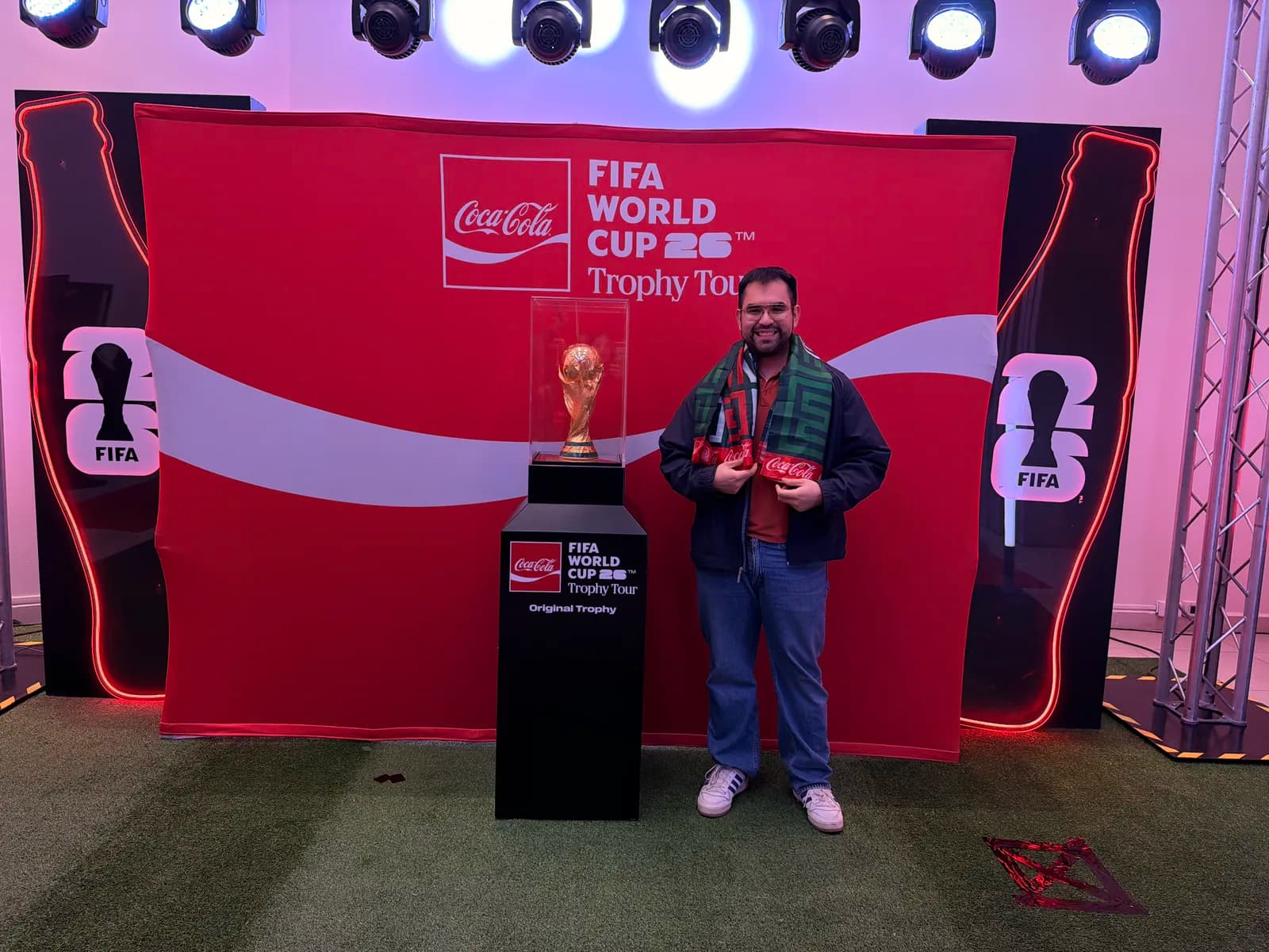 Arturo beside the FIFA World Cup trophy at an Arca Continental event